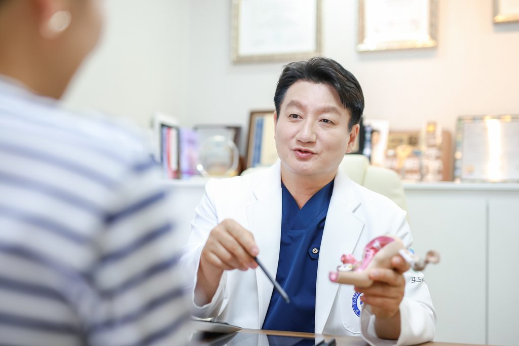 Dr. Mo Hyung-jin pointing to the pelvic ligaments on an anatomical model